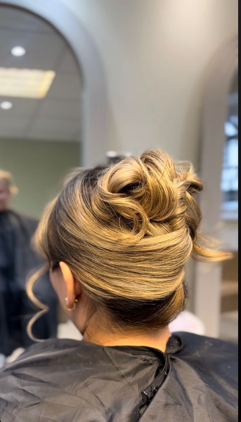 High curled updo in blonde tones, finished in the salon chair